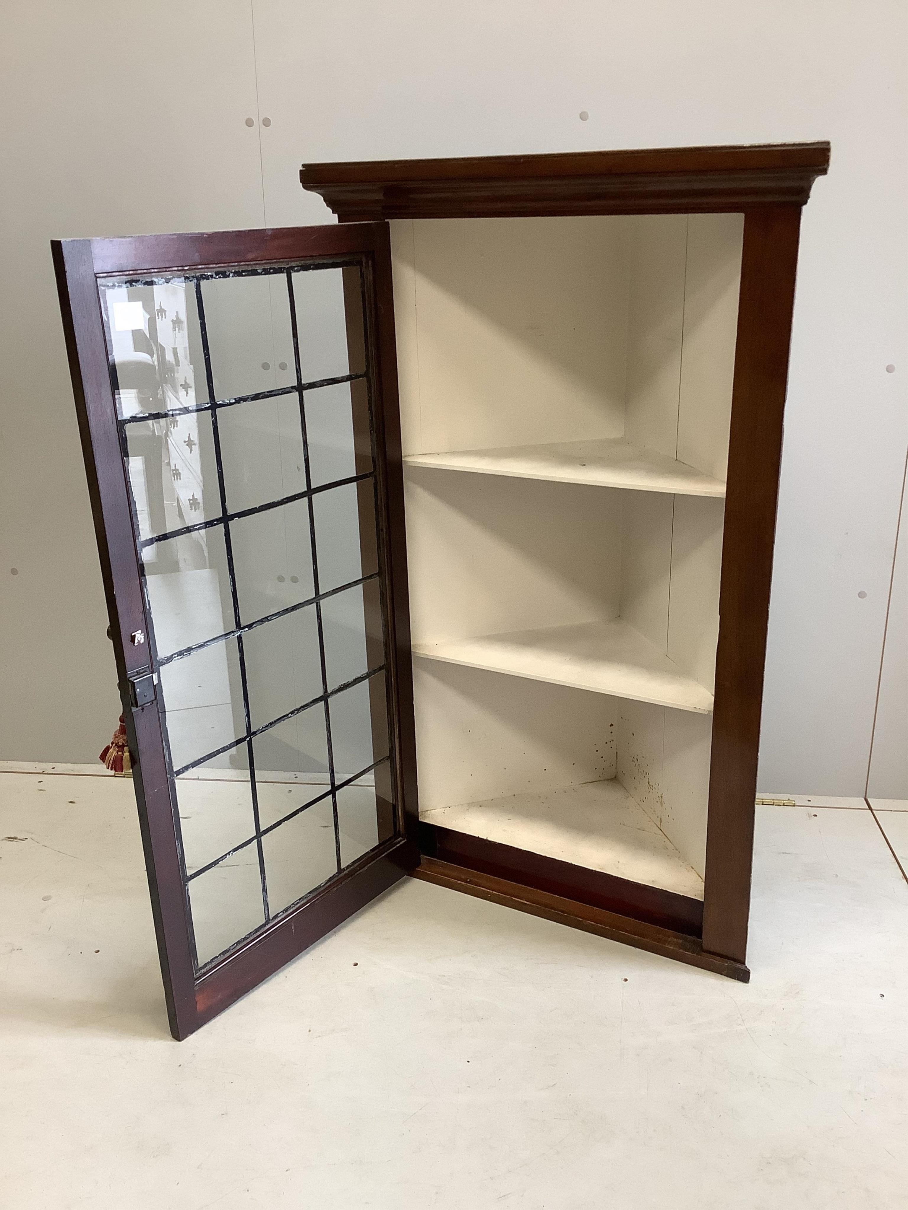 A George III style glazed mahogany hanging corner cabinet, with leaded glazing bars, width 77cm, depth 38cm, height 124cm. Condition - fair